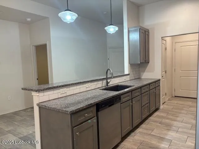 a kitchen with granite countertop a stove and a sink