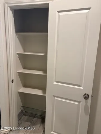 an empty room with closet and mirror