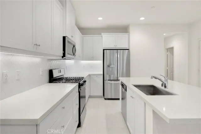a kitchen with a sink a stove and refrigerator