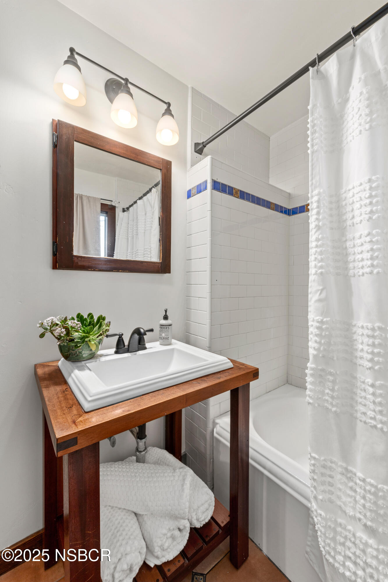 616 Alisal Road Solvang, CA 93463 - Photo 11 of 35 a bathroom with a sink and a mirror