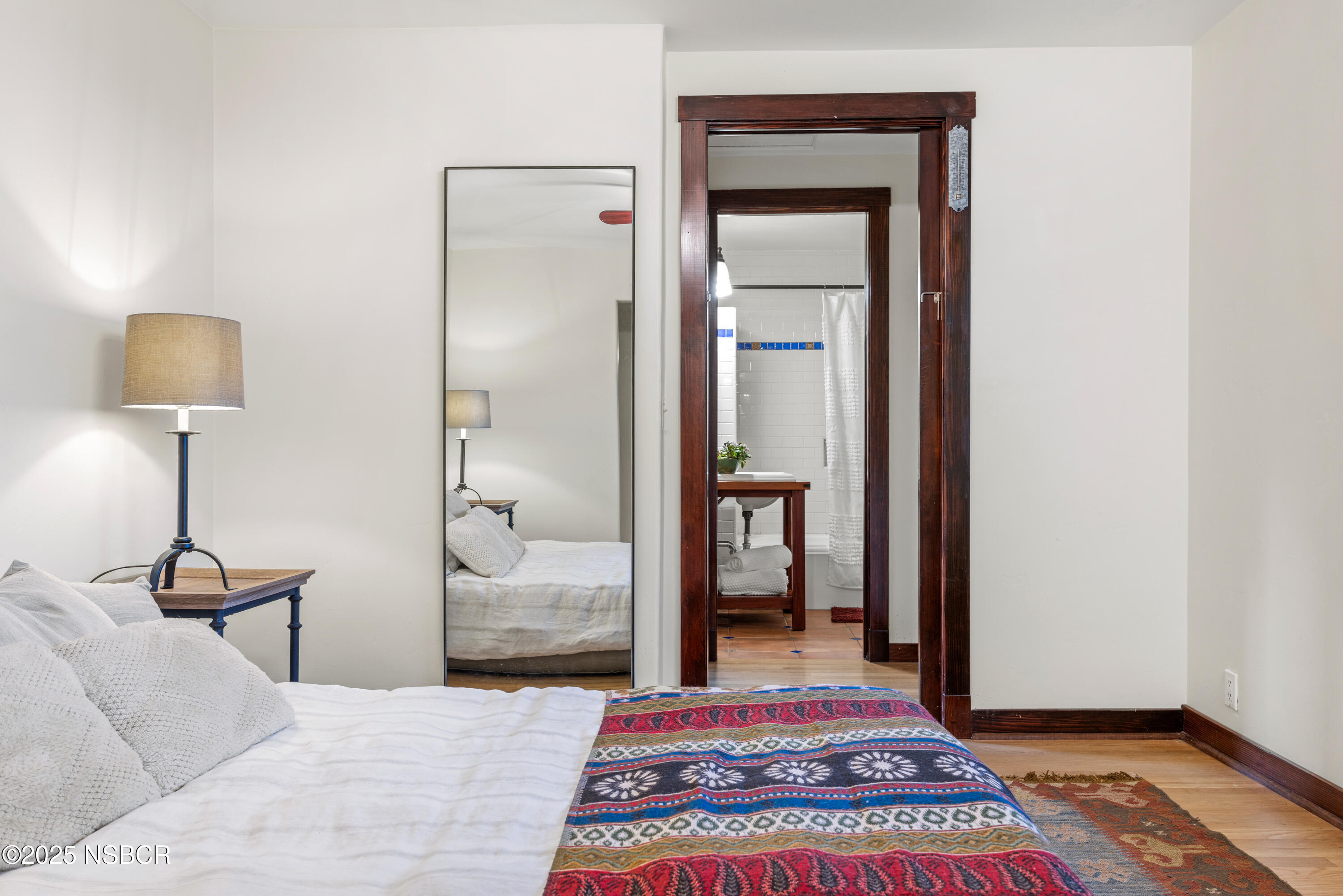 616 Alisal Road Solvang, CA 93463 - Photo 19 of 35 a bedroom with a bed and a lamp on table