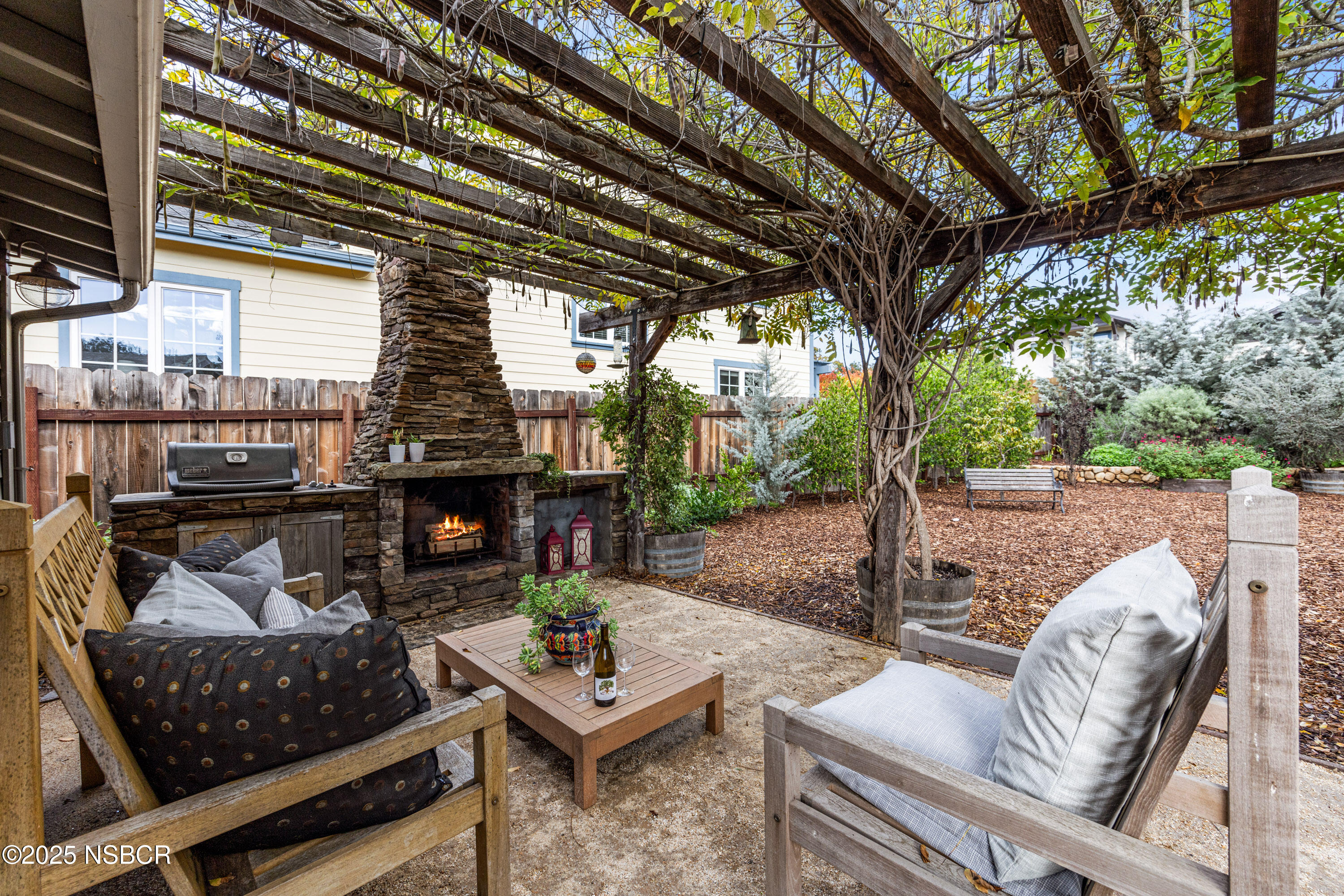 616 Alisal Road Solvang, CA 93463 - Photo 24 of 35 a outdoor living space with patio furniture and a fireplace