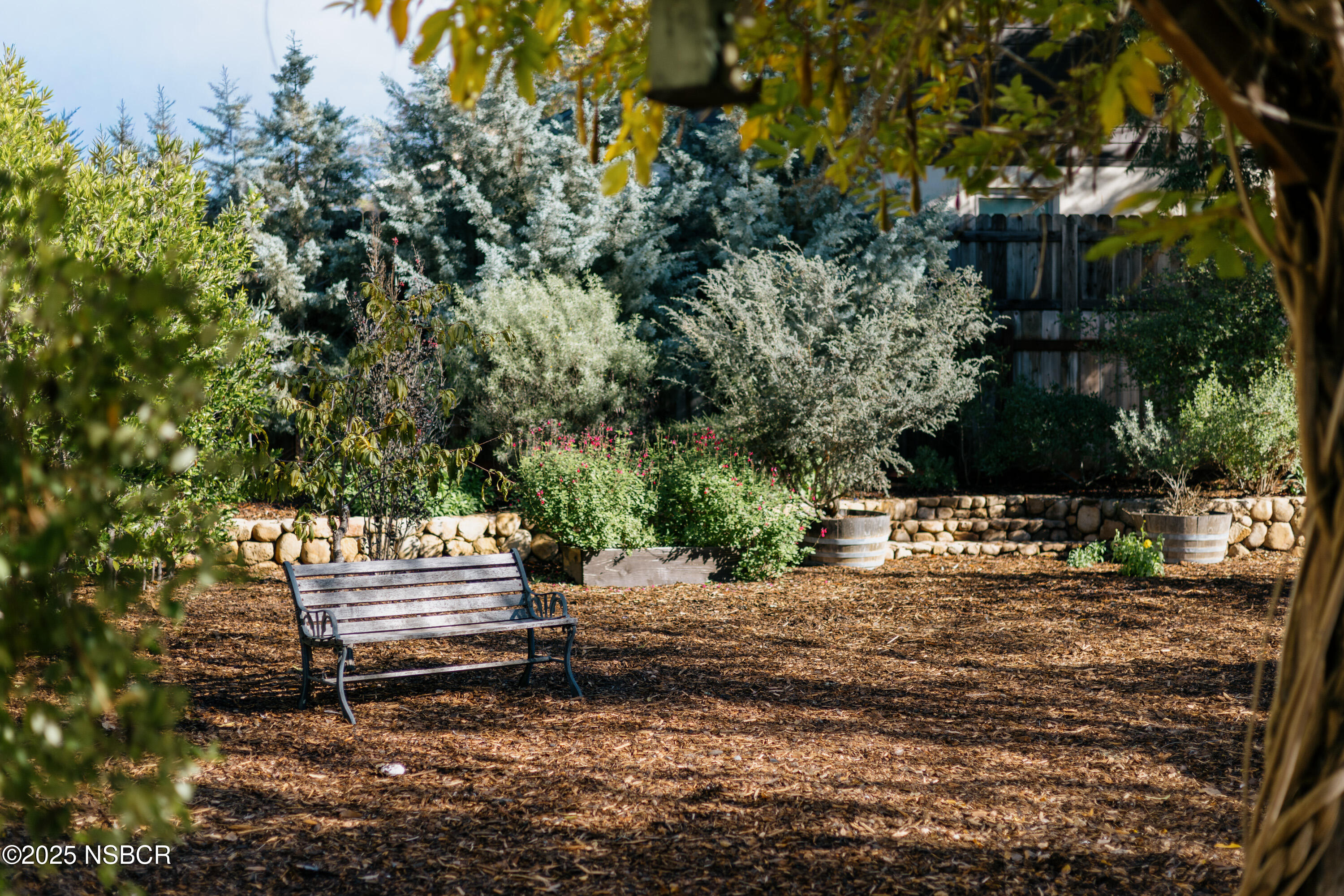 616 Alisal Road Solvang, CA 93463 - Photo 34 of 35 a backyard of a house with large trees and outdoor seating