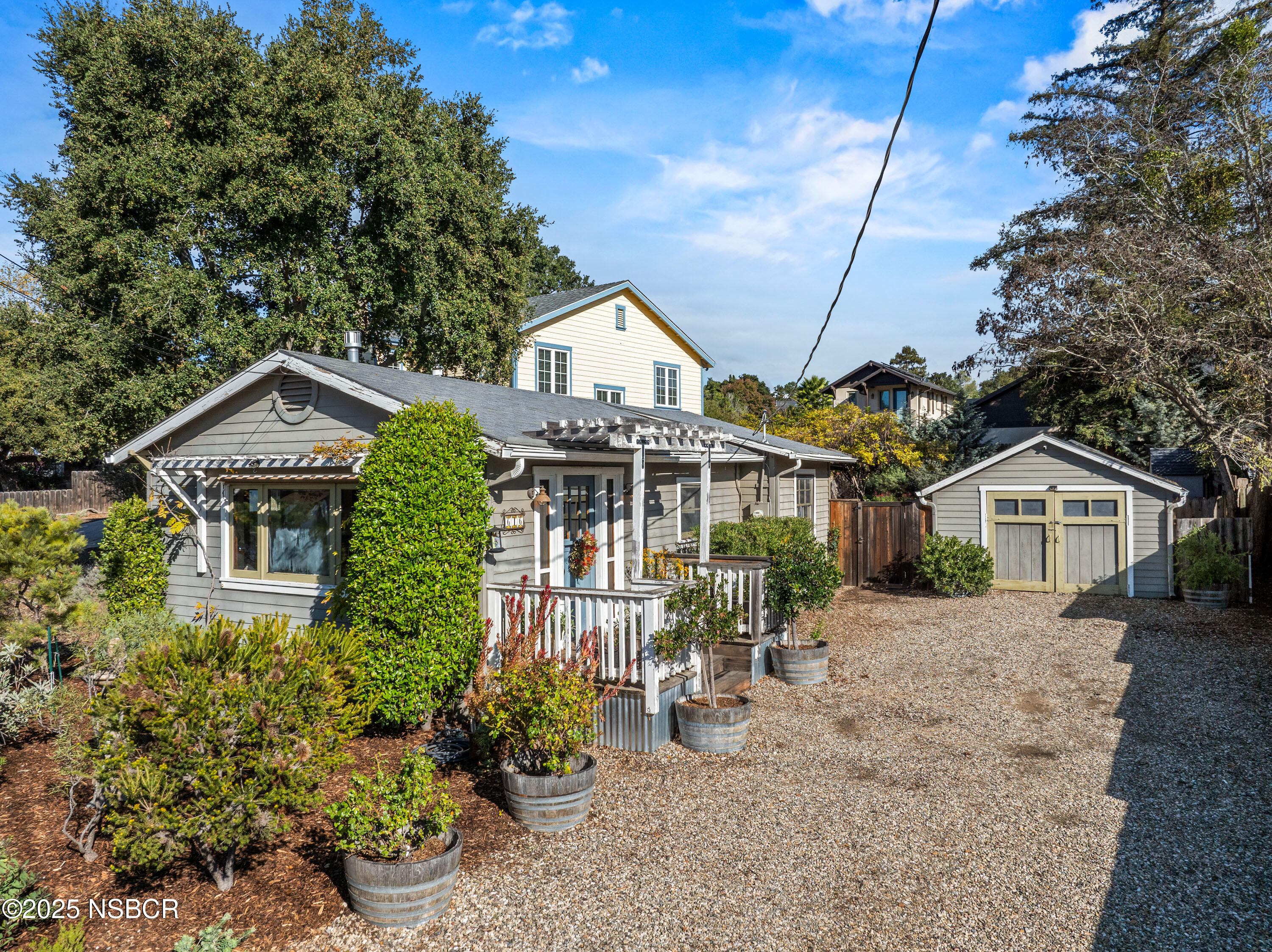 616 Alisal Road Solvang, CA 93463 - Photo 35 of 35 a front view of a house with a yard and potted plants