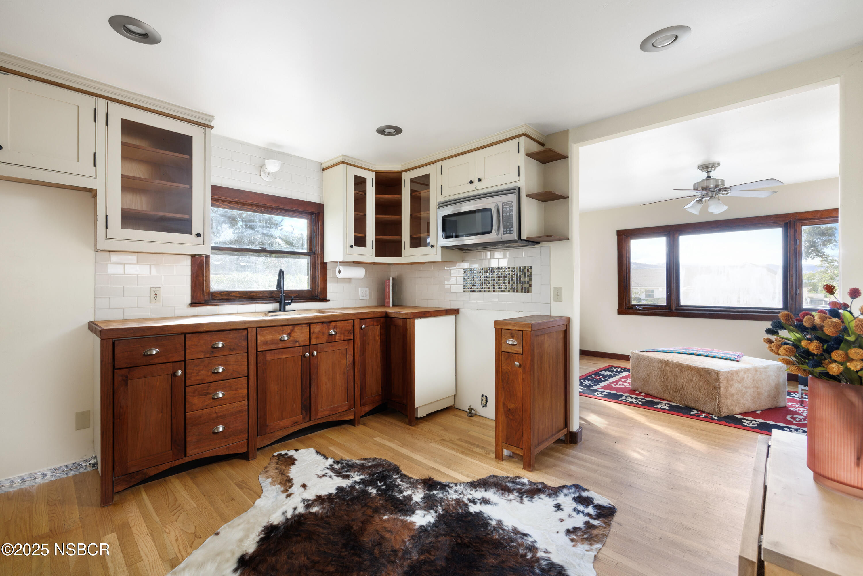 616 Alisal Road Solvang, CA 93463 - Photo 5 of 35 a kitchen with stainless steel appliances granite countertop a sink dishwasher stove and refrigerator with wooden floor