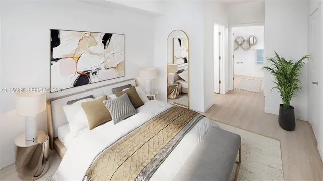 a bedroom with a bed and a potted plant