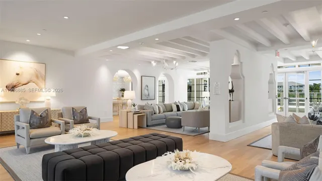 a living room with furniture kitchen and a chandelier