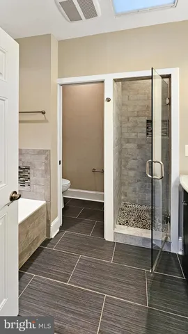 a bathroom with a shower and a bathtub