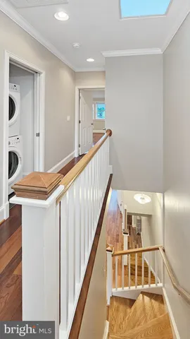 a view of entryway and hall with wooden floor