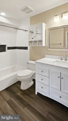 a bathroom with a sink toilet a mirror and shower