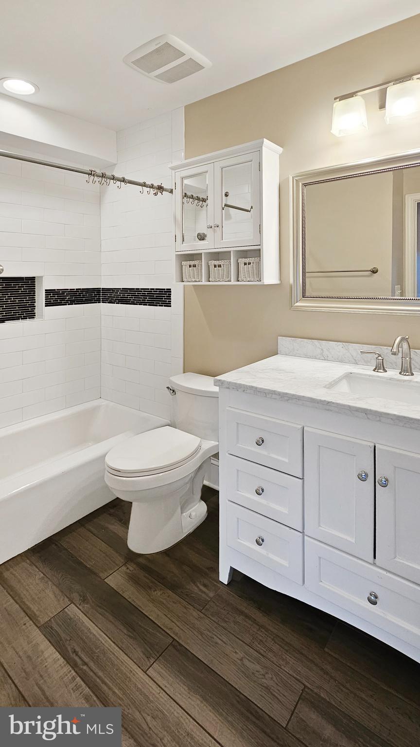 1834 Massachusetts Avenue Southeast Washington, DC 20003 - Photo 9 of 25 a bathroom with a sink toilet a mirror and shower