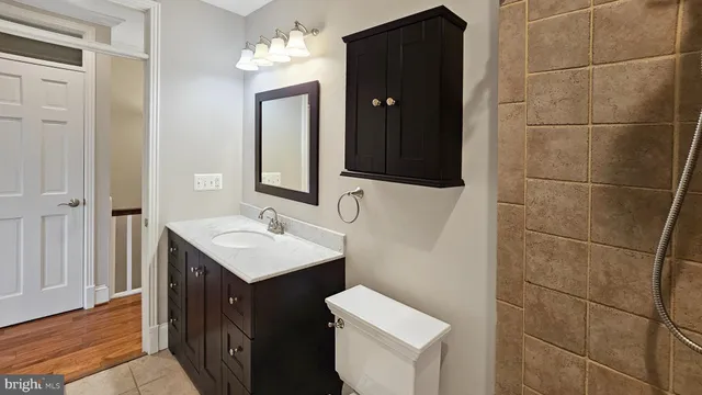 a bathroom with a sink toilet and mirror