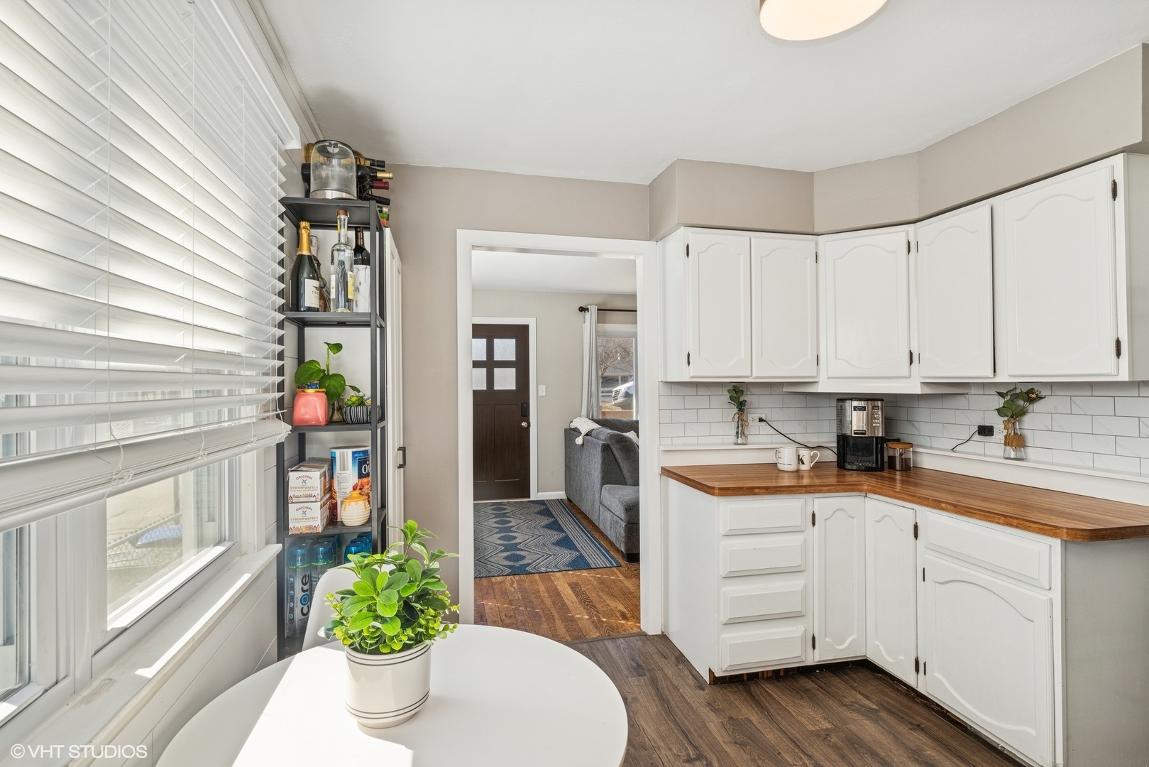 5414 Thelen Drive McHenry, IL 60051 - Photo 6 of 18 a kitchen with a white stove top oven and white cabinets with wooden floor
