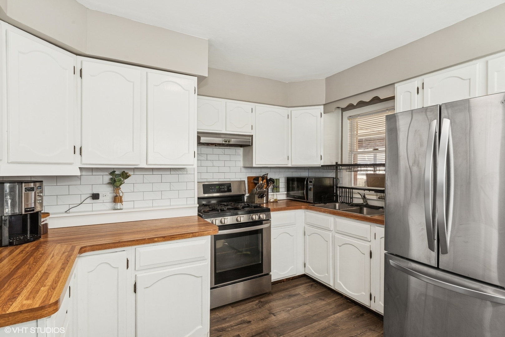 5414 Thelen Drive McHenry, IL 60051 - Photo 7 of 18 a kitchen with white cabinets and white appliances