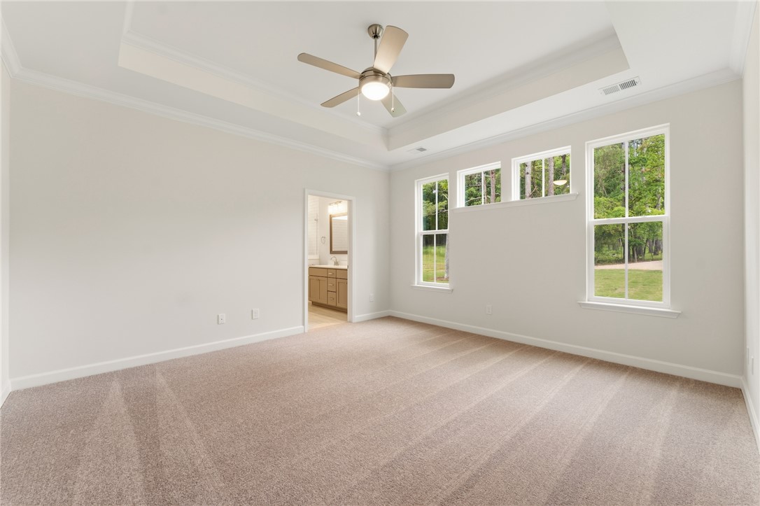 110 Lakeside Drive Anderson, SC 29621 - Photo 18 of 34 An inviting primary bedroom with ample natural light, soft carpeting, and an adjacent private bathroom.