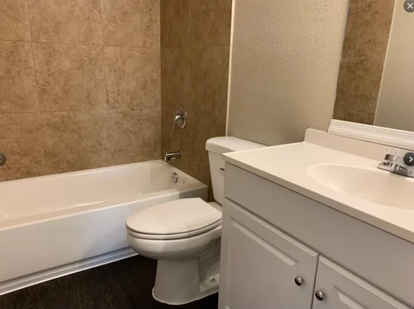 a bathroom with a sink a toilet and a bathtub