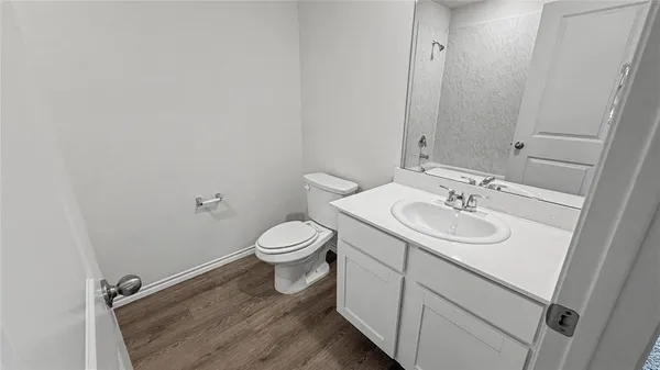 a bathroom with a sink toilet and vanity