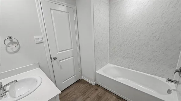 a bathroom with a tub and sink