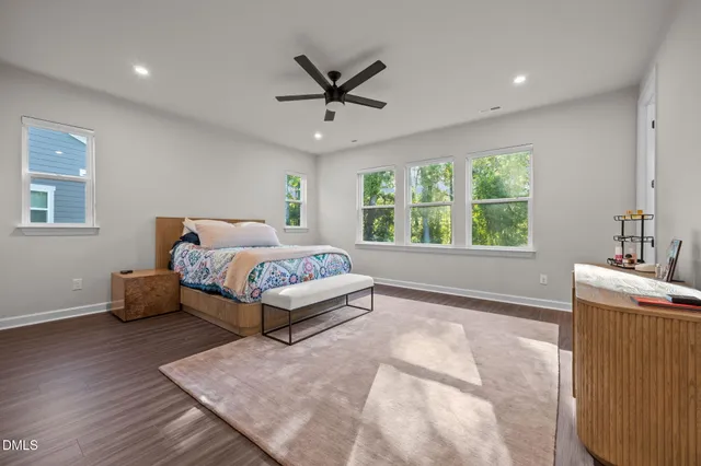 a bedroom with a large bed and a window