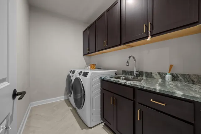 a utility room with sink dryer and washer