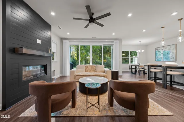 a living room with furniture a large window and a table
