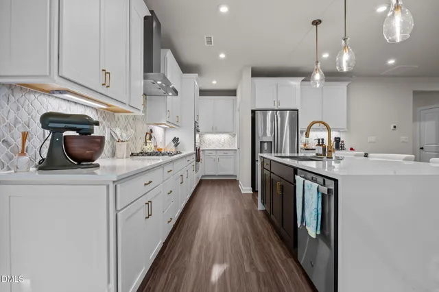 a kitchen with cabinets a sink and appliances