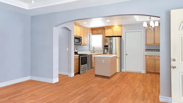 a view of a kitchen with wooden floor