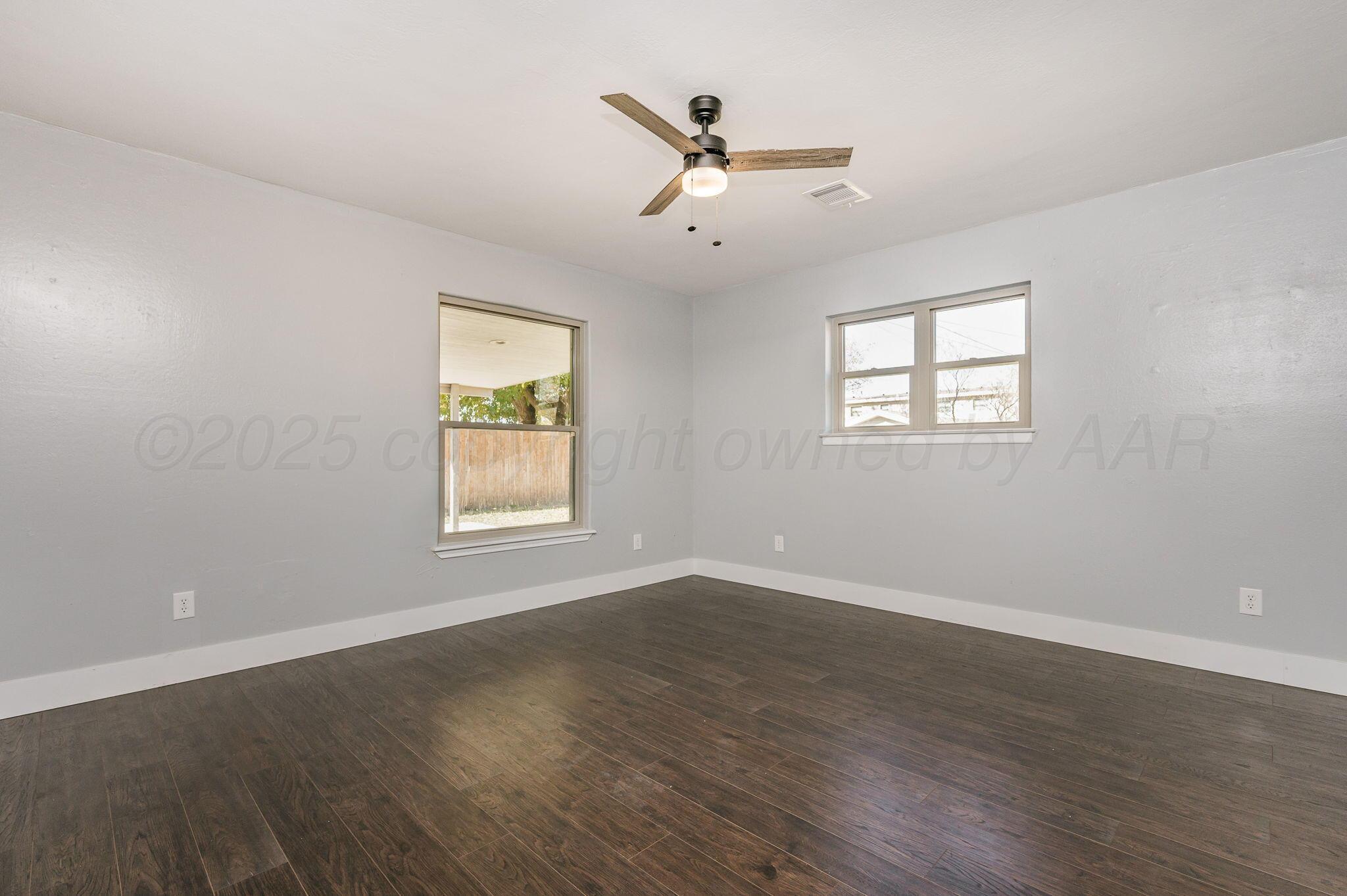 6218 Adirondack Trail Amarillo, TX 79106 - Photo 12 of 26 a view of an empty room with wooden floor and a window
