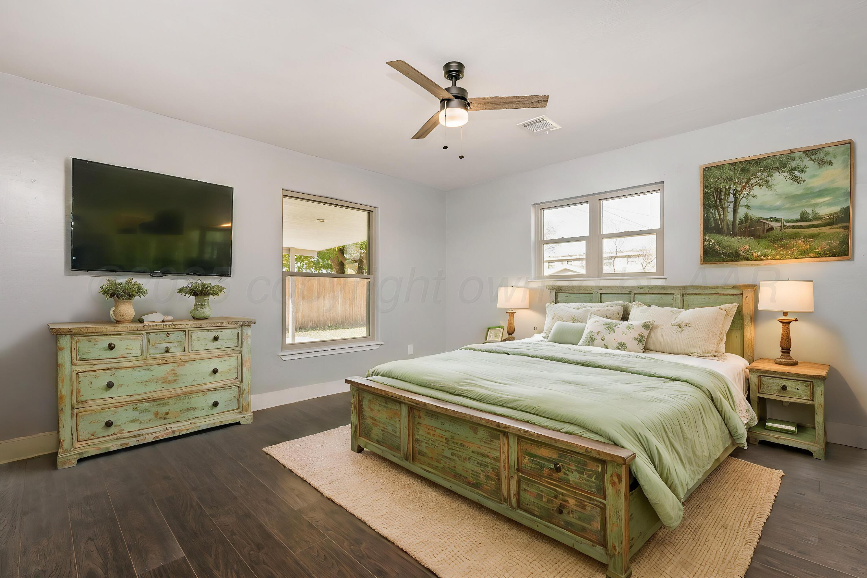 6218 Adirondack Trail Amarillo, TX 79106 - Photo 13 of 26 a spacious bedroom with a bed and a flat screen tv
