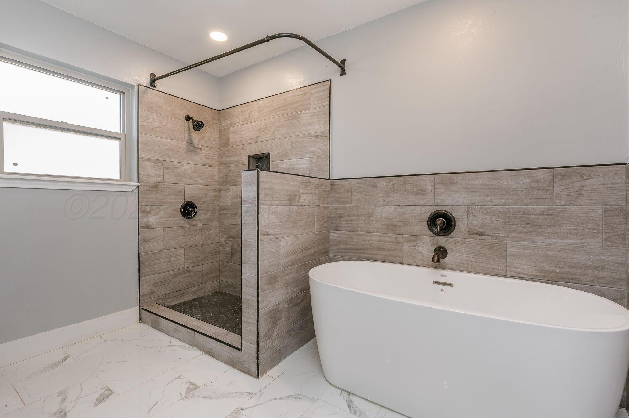 6218 Adirondack Trail Amarillo, TX 79106 - Photo 15 of 26 a white bath tub sitting next to a shower