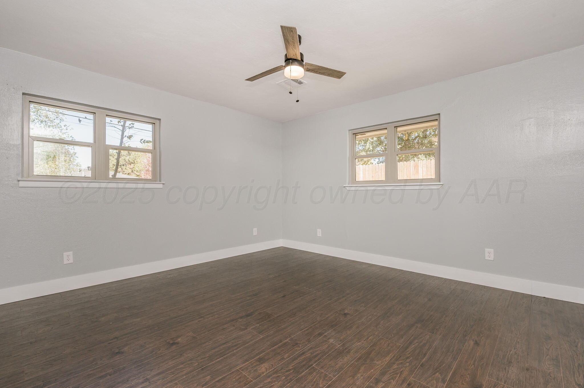 6218 Adirondack Trail Amarillo, TX 79106 - Photo 16 of 26 a view of an empty room with wooden floor and a window