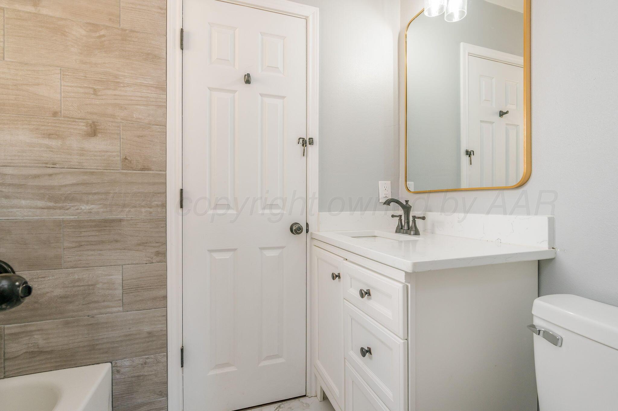 6218 Adirondack Trail Amarillo, TX 79106 - Photo 17 of 26 a bathroom with a sink a toilet and shower