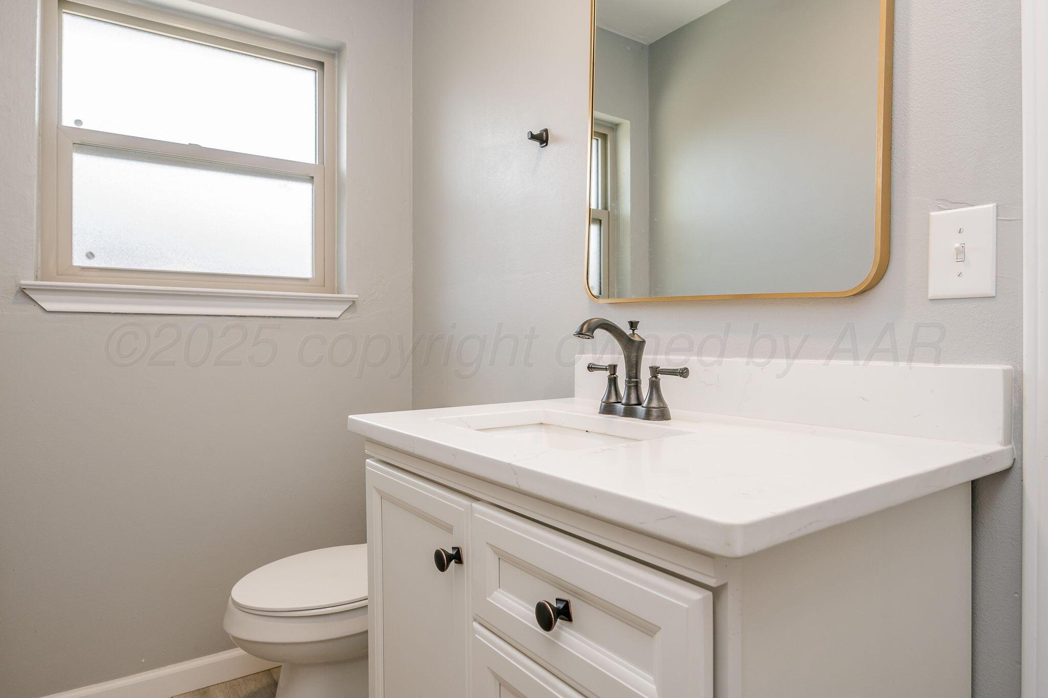 6218 Adirondack Trail Amarillo, TX 79106 - Photo 21 of 26 a bathroom with a sink a toilet and a mirror
