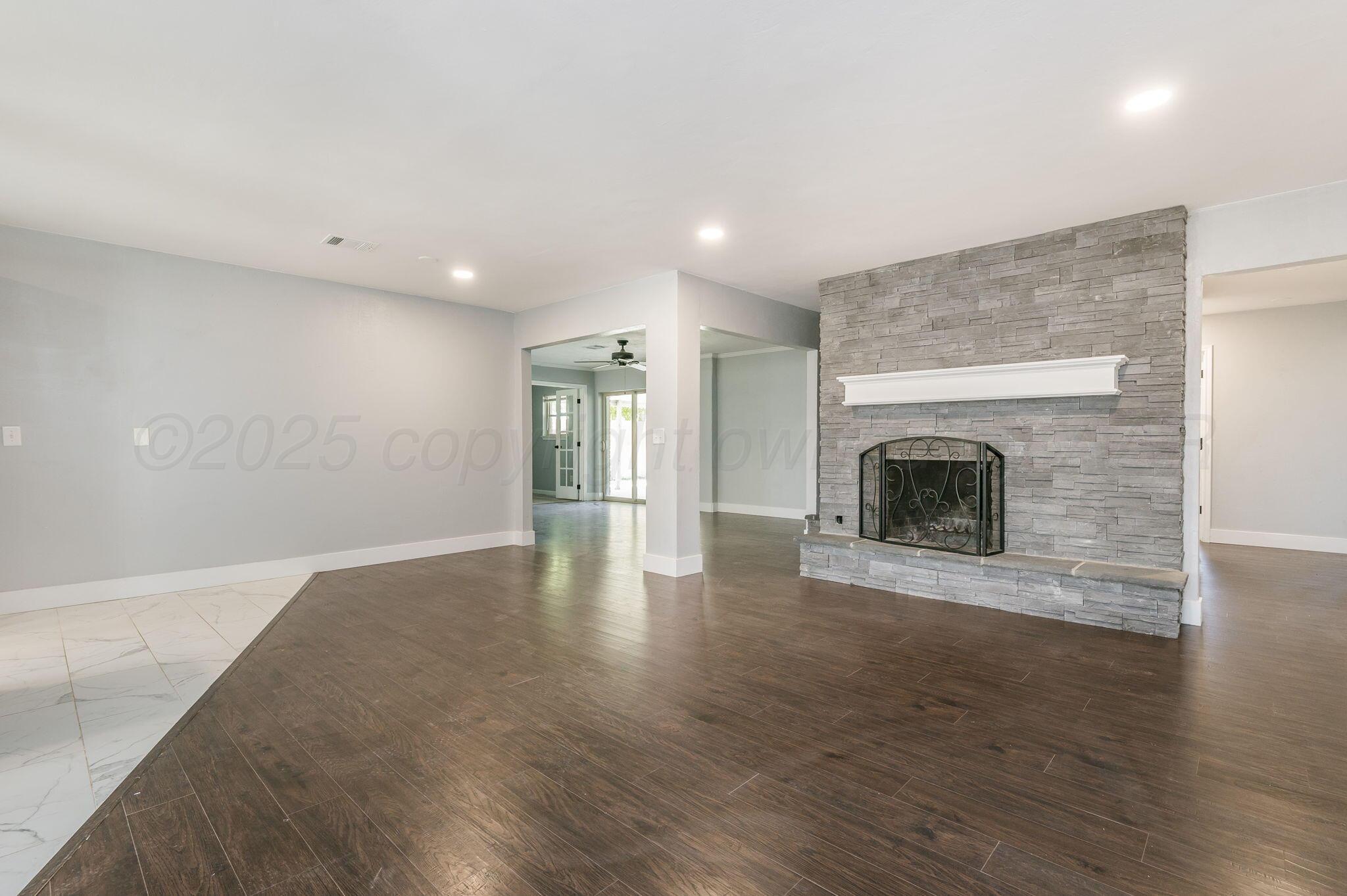 6218 Adirondack Trail Amarillo, TX 79106 - Photo 3 of 26 a view of empty room with wooden floor and fireplace