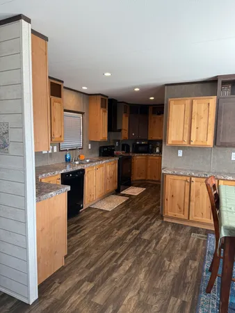 a kitchen with a sink wooden cabinets and stainless steel appliances