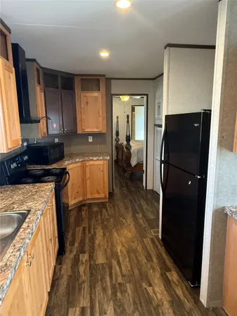 a view of a hallway with wooden floor and closet