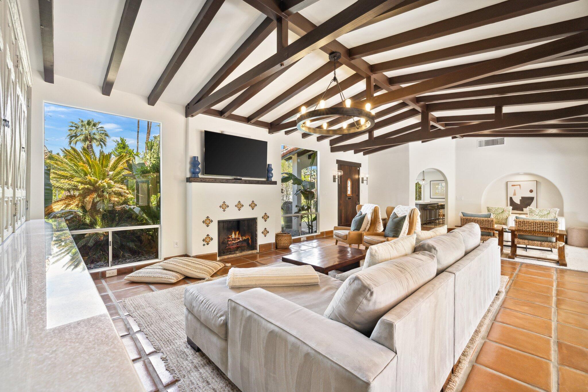 435 West Vereda Sur Palm Springs, CA 92262 - Photo 13 of 80 a living room with furniture a fireplace and a flat screen tv