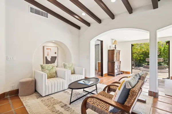 a dining room with furniture a chandelier and a rug