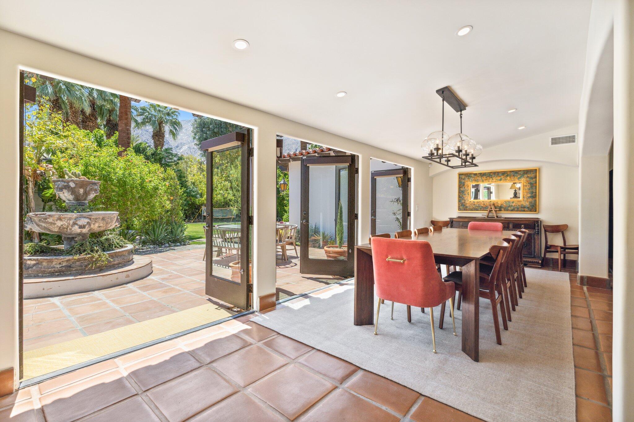 435 West Vereda Sur Palm Springs, CA 92262 - Photo 19 of 80 a dining room with furniture water view and a floor to ceiling window