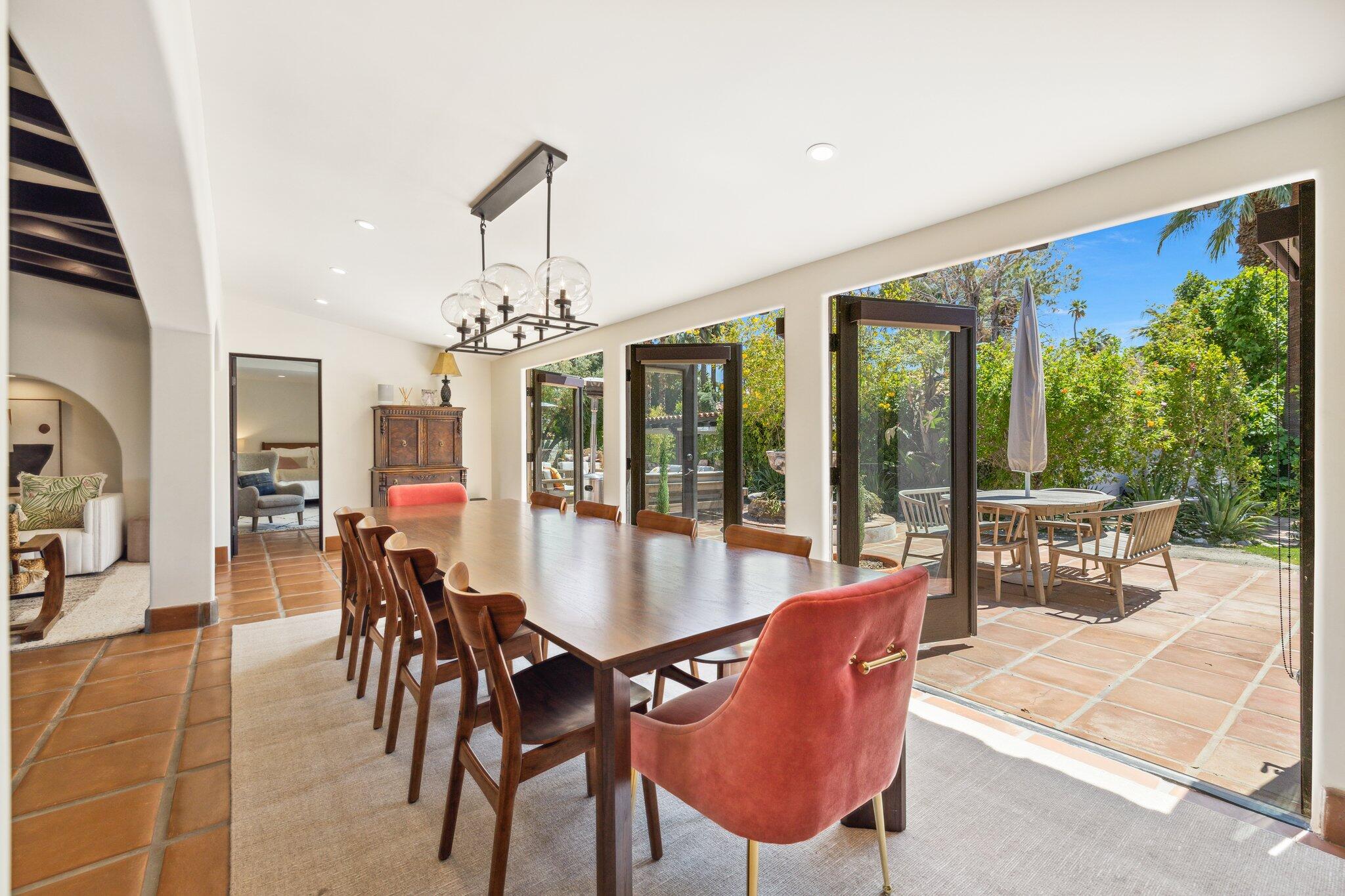 435 West Vereda Sur Palm Springs, CA 92262 - Photo 20 of 80 a dining room with furniture a chandelier and a rug