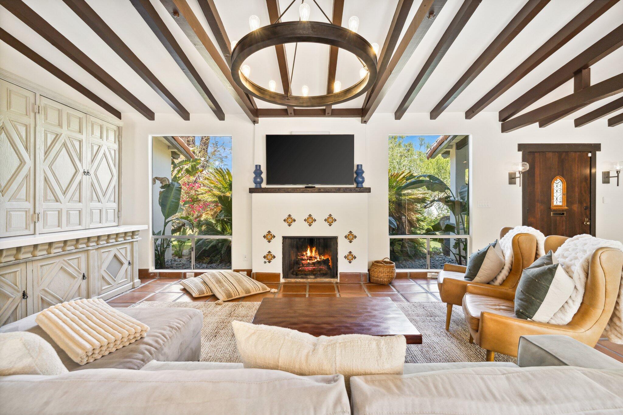 435 West Vereda Sur Palm Springs, CA 92262 - Photo 2 of 80 a living room with furniture a fireplace and a flat screen tv