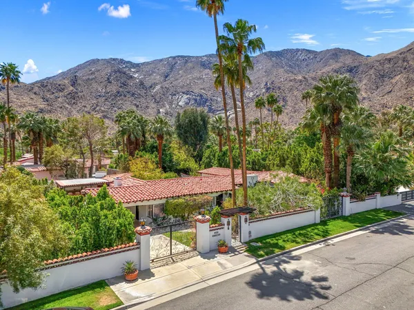 a view of a patio with a table and chairs under an umbrella