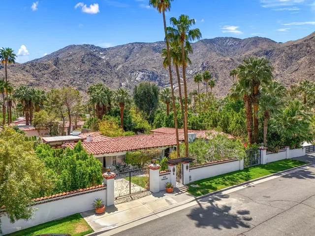 a view of a patio with a table and chairs under an umbrella