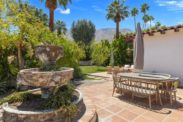 a kitchen with stainless steel appliances granite countertop a sink a stove and a wooden floors