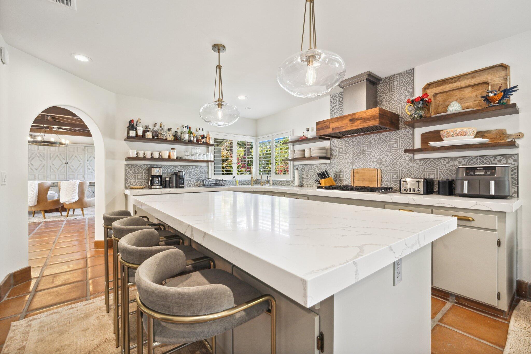 435 West Vereda Sur Palm Springs, CA 92262 - Photo 51 of 80 a kitchen with stainless steel appliances granite countertop a sink a stove and a wooden floors