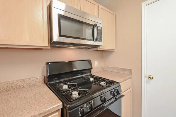 a stove top oven sitting inside of a kitchen