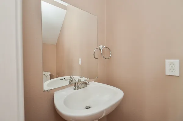 a bathroom with a sink and mirror
