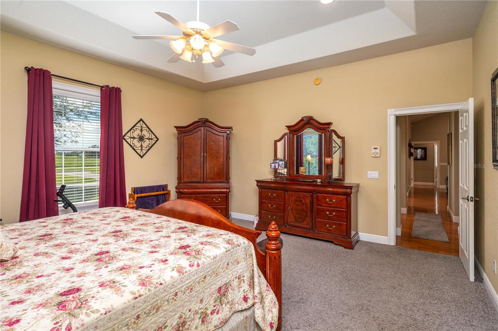 35 Stembridge Road Lake Wales, FL 33898 - Photo 19 of 61 a bedroom with a bed and a chandelier