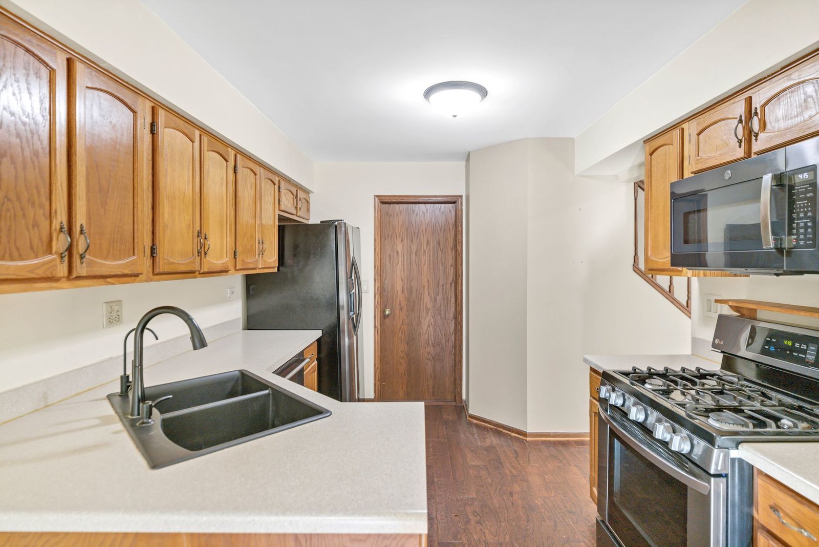 2116 Glasgow Court, Unit 2116 Hanover Park, IL 60133 - Photo 14 of 29 a kitchen with stainless steel appliances granite countertop a sink stove and refrigerator