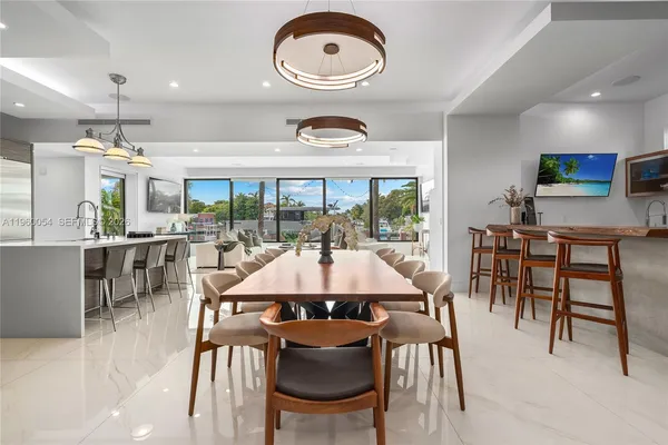 a view of a dining room with furniture and chandelier